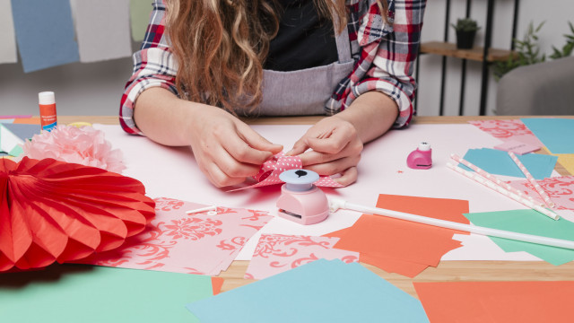 female-artist-hand-making-pinwheel-using-origami-paper-1-124